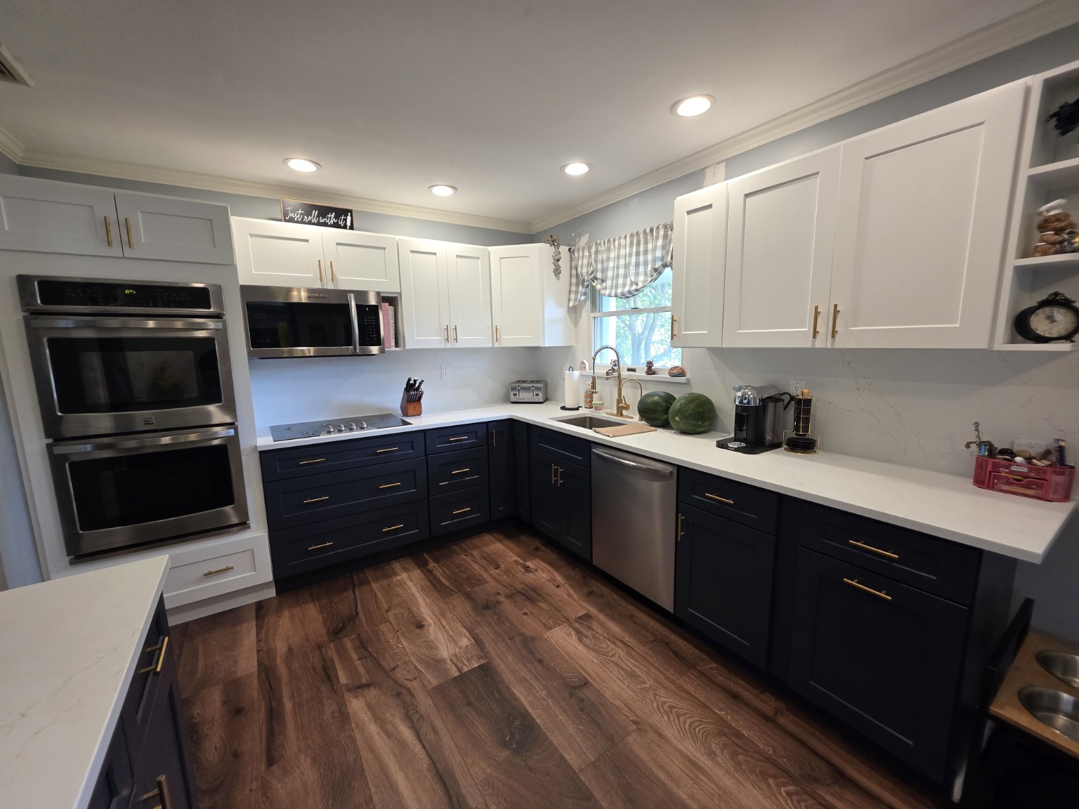 Completed two-tone kitchen with white upper and navy lower Shaker cabinets