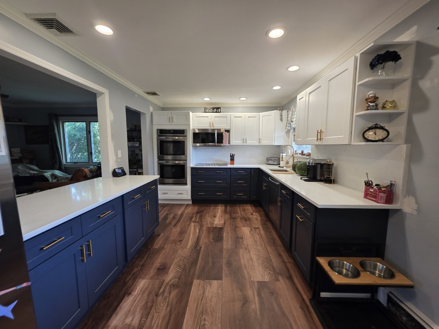Wide view of completed navy and white Shaker kitchen