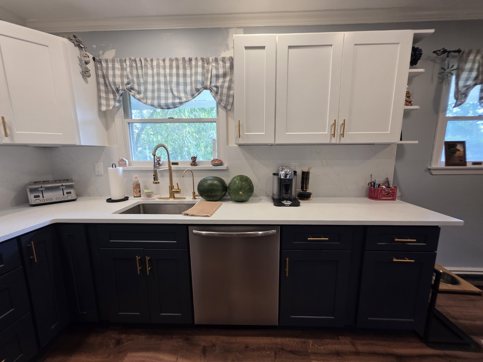 Completed sink wall with navy and white Shaker cabinetry